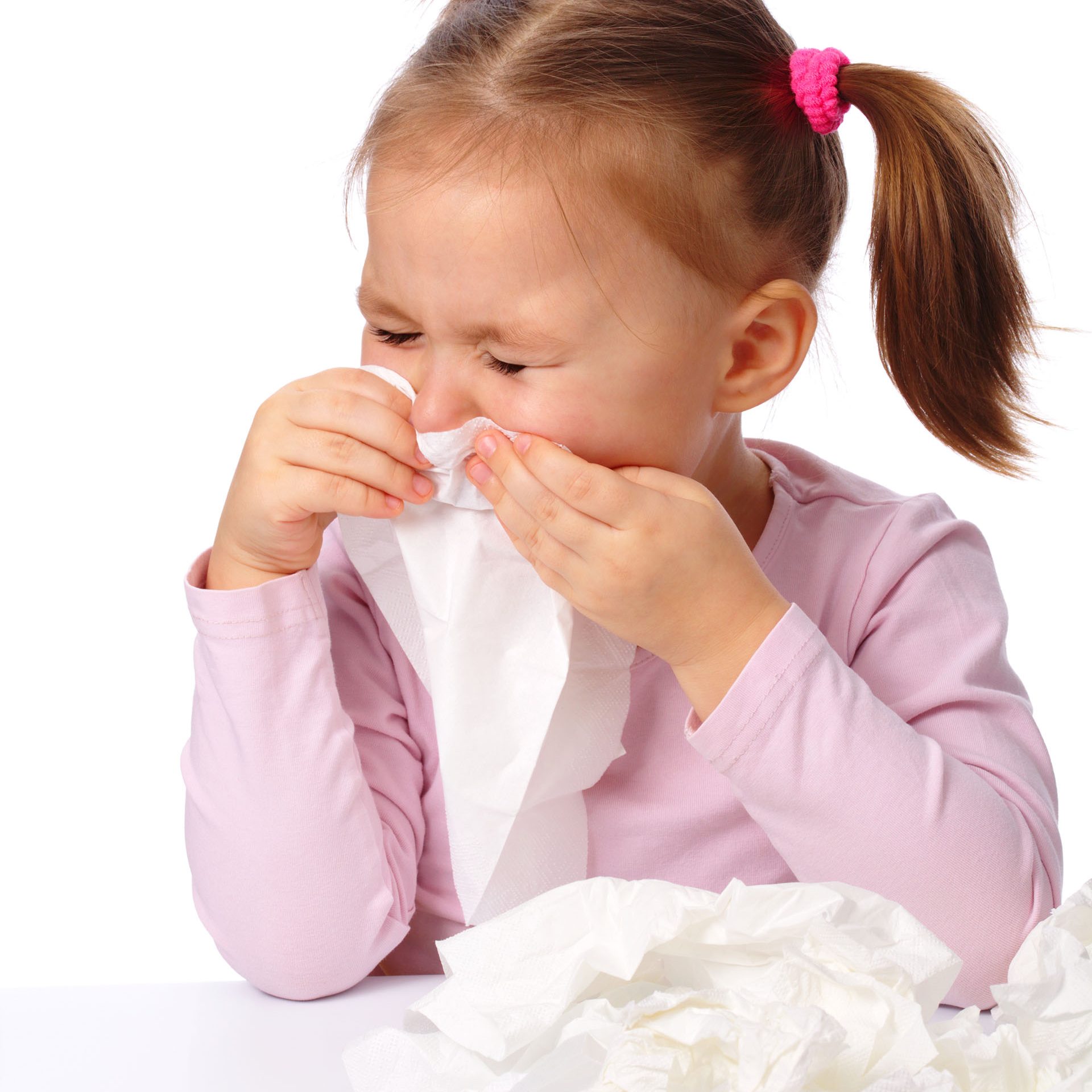 Little girl blows her nose, isolated over white